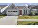 Gray siding house with red door, two-car garage, and landscaped lawn at 253 River Martin Ct, Summerville, SC 29483
