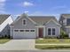 Gray Craftsman style home with a two-car garage and red door at 253 River Martin Ct, Summerville, SC 29483