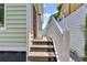Wooden steps leading to the back entrance with white railing at 40 Morris St, Charleston, SC 29403