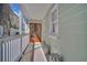 Covered porch with white railing and decorative ceramic stools at 40 Morris St, Charleston, SC 29403
