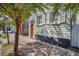 Quaint light green house with white shutters and a wooden door at 40 Morris St, Charleston, SC 29403