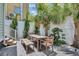 Private patio with wooden table, chairs, and lush landscaping at 40 Morris St, Charleston, SC 29403