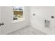 Bright laundry room with white cabinets and marble floor at 123 Ashley Cove Way, Summerville, SC 29483