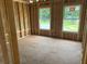 New construction bedroom with wood framing and two windows at 123 Ashley Cove Way, Summerville, SC 29483