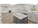Open floor plan with kitchen island, hardwood floors, and a fireplace at 123 Ashley Cove Way, Summerville, SC 29483