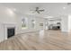 Open living room with hardwood floors, fireplace and kitchen view at 123 Ashley Cove Way, Summerville, SC 29483