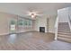 Spacious living room featuring hardwood floors, fireplace, and access to backyard at 537 Rendezvous Way, Huger, SC 29450