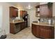 Efficient kitchen with dark wood cabinets, tile backsplash, and stainless steel appliances at 7828 Peppercorn Ln, North Charleston, SC 29420