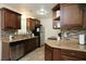 Efficient kitchen with dark wood cabinets, tile backsplash, and stainless steel appliances at 7828 Peppercorn Ln, North Charleston, SC 29420