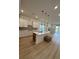 Modern kitchen with white cabinets, island, and hardwood floors at 4416 Oakwood Ave, North Charleston, SC 29405