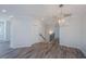 Dining area with chandelier and gray vinyl flooring, open to kitchen at 420 Carolina Cherry Ct # 203, Charleston, SC 29414