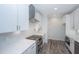 Bright kitchen with white cabinets, herringbone backsplash, and stainless steel appliances at 420 Carolina Cherry Ct # 203, Charleston, SC 29414