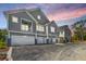 Gray townhouses with attached garages, and a shared driveway at 420 Carolina Cherry Ct # 203, Charleston, SC 29414