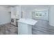 Open concept kitchen with white island, quartz countertops, and stainless steel appliances at 420 Carolina Cherry Ct # 203, Charleston, SC 29414