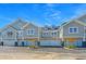 Three-unit townhouse building with attached garages and landscaping at 420 Carolina Cherry Ct # 203, Charleston, SC 29414