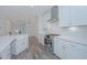Modern kitchen with white cabinets, farmhouse sink, and stainless steel appliances at 420 Carolina Cherry Ct # 203, Charleston, SC 29414