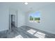 Spacious bedroom with gray vinyl plank flooring and large window at 420 Carolina Cherry Ct # 203, Charleston, SC 29414