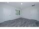 Bright bedroom with grey wood-look flooring and multiple windows at 420 Carolina Cherry Ct # 203, Charleston, SC 29414