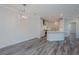 Open concept dining room with modern chandelier and gray flooring at 420 Carolina Cherry Ct # 203, Charleston, SC 29414