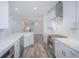 Modern kitchen with white cabinets, stainless steel appliances, and herringbone backsplash at 420 Carolina Cherry Ct # 203, Charleston, SC 29414