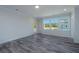 Spacious living room with gray vinyl flooring and large windows at 420 Carolina Cherry Ct # 203, Charleston, SC 29414