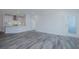 Open living room with kitchen view and gray vinyl plank flooring at 420 Carolina Cherry Ct # 203, Charleston, SC 29414