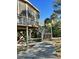 Elevated home exterior with wooden stairs leading to a dock at 3001 Buccaneer Rd, Isle of Palms, SC 29451