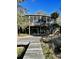 Elevated home with a large screened porch and dock access at 3001 Buccaneer Rd, Isle of Palms, SC 29451