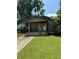 Boarded-up house with overgrown lawn and damaged steps at 17 Reid St, Charleston, SC 29403