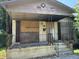 A neglected house with boarded-up windows and doors at 17 Reid St, Charleston, SC 29403