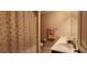 Bathroom with double vanity and rainbow shower curtain at 9120 Parlor Dr, Ladson, SC 29456