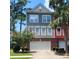 Two-story townhome with gray and red siding, two-car garage, and landscaping at 9120 Parlor Dr, Ladson, SC 29456