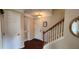 Bright entryway with hardwood floors, coat closet, and staircase at 9120 Parlor Dr, Ladson, SC 29456