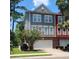 Two-story townhome with gray and red siding, two-car garage, and landscaping at 9120 Parlor Dr, Ladson, SC 29456