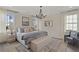 Spacious main bedroom with a king-size bed, chandelier, and seating area at 702 Maynard Ln, Summerville, SC 29486