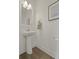 Cozy powder room features pedestal sink, framed mirror, and modern light fixture at 702 Maynard Ln, Summerville, SC 29486