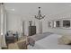 Elegant main bedroom with a king-size bed, chandelier, and access to the bathroom at 702 Maynard Ln, Summerville, SC 29486