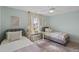Well-lit bedroom with twin beds, light walls, and a workspace at 702 Maynard Ln, Summerville, SC 29486