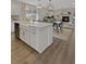 Modern eat-in kitchen with a large island and white cabinetry at 702 Maynard Ln, Summerville, SC 29486