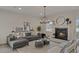 Spacious living room with fireplace, comfortable seating, and large windows at 702 Maynard Ln, Summerville, SC 29486