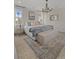 Luxurious main bedroom with a king bed, chandelier, and bench at the foot of the bed at 702 Maynard Ln, Summerville, SC 29486