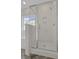 Modern shower features marble tile, niche storage, and glass door at 702 Maynard Ln, Summerville, SC 29486