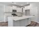 Modern kitchen boasts white cabinets, quartz countertops, and a gold faucet at 111 Ashley Cove Way, Summerville, SC 29483