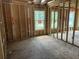 New construction framing shows large room with multiple windows overlooking yard at 111 Ashley Cove Way, Summerville, SC 29483