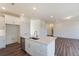 Open concept kitchen with island, white cabinets and stainless steel appliances at 111 Ashley Cove Way, Summerville, SC 29483