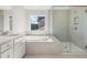 Bright bathroom features a double sink vanity, soaking tub, and glass shower at 111 Ashley Cove Way, Summerville, SC 29483