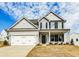 Two-story house with gray siding, white garage doors, and landscaping at 111 Ashley Cove Way, Summerville, SC 29483