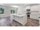Open concept kitchen with island, white cabinets, and stainless steel appliances at 111 Ashley Cove Way, Summerville, SC 29483