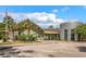 Inviting building with manicured landscaping, palm trees, and an American flag waving in front under a partly cloudy sky at 111 Ashley Cove Way, Summerville, SC 29483