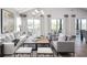 Spacious living room with hardwood floors, large windows, and comfortable seating at 66 Cooper St, Charleston, SC 29403
